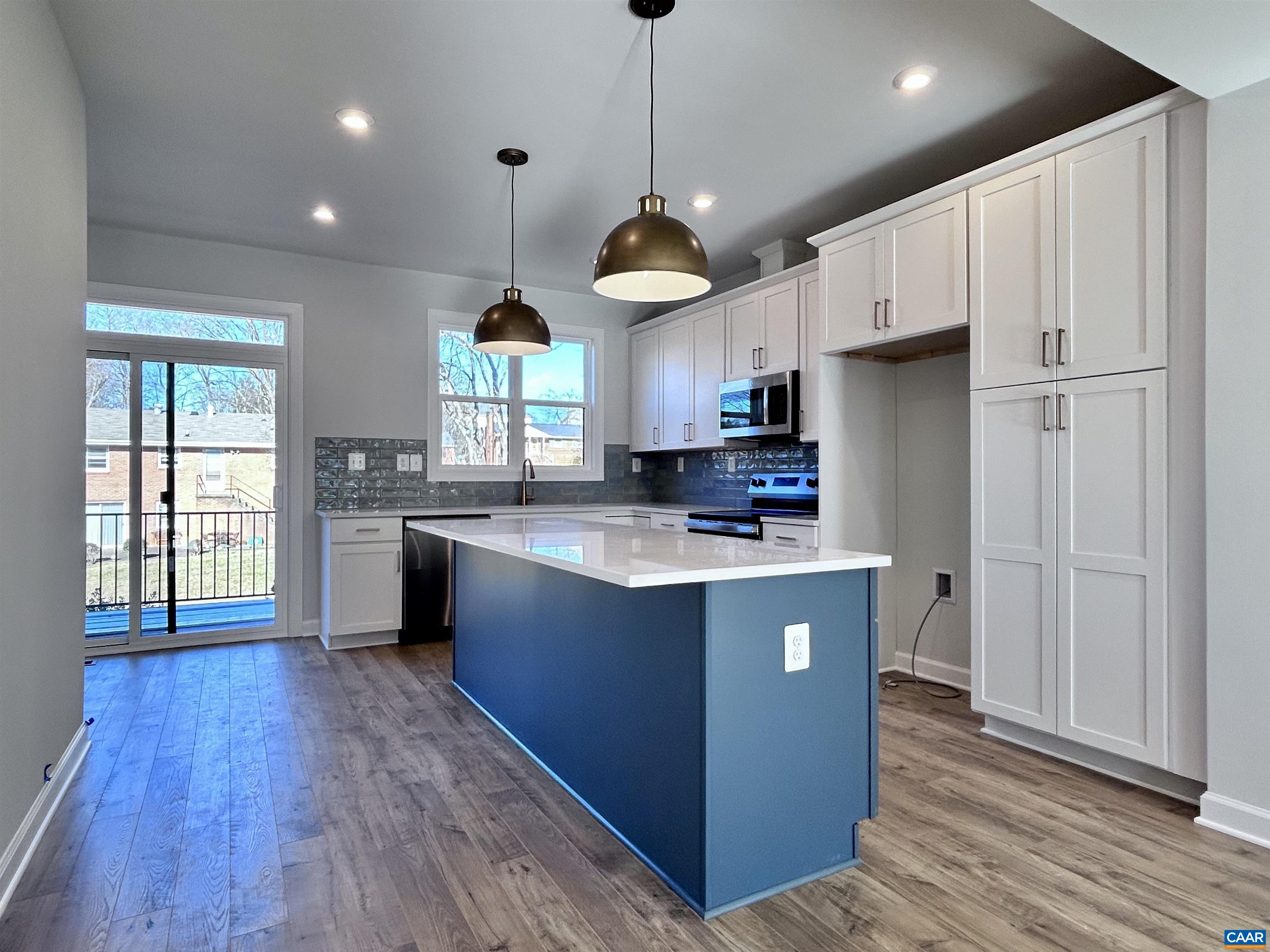 103 Keene Court Charlottesville, VA 22903 - Photo 5 of 18 a kitchen with kitchen island granite countertop wooden floors stainless steel appliances and window
