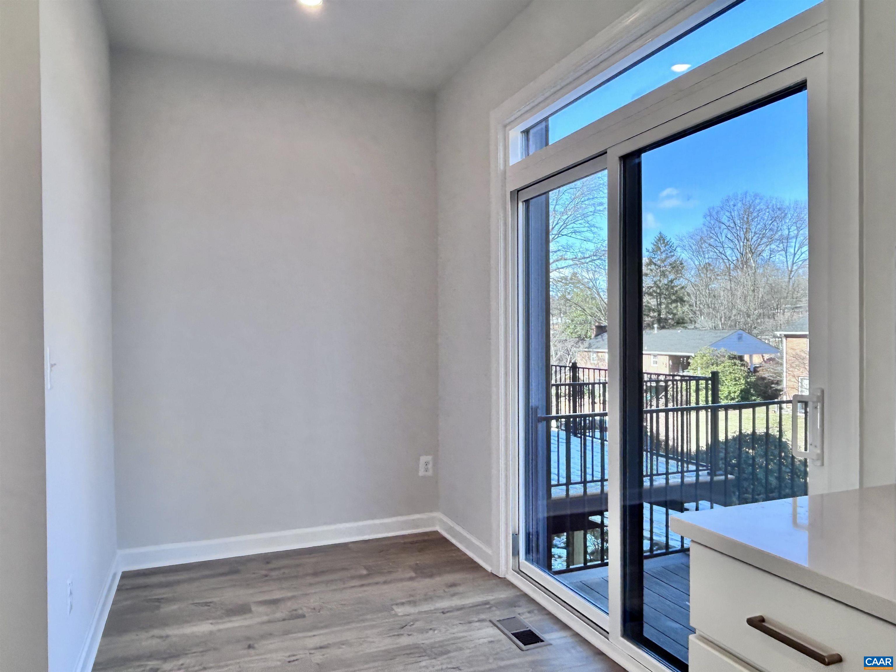 103 Keene Court Charlottesville, VA 22903 - Photo 8 of 18 a view of an empty room with wooden floor and a window