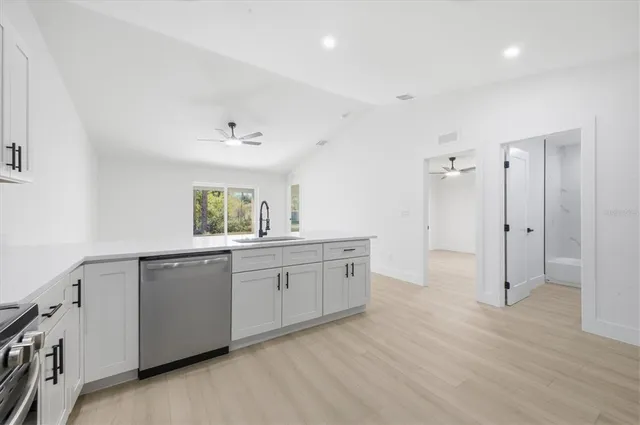 a spacious bathroom with a granite countertop sink mirror and a bathtub