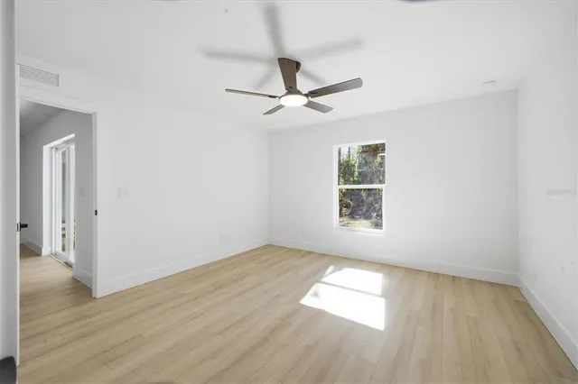wooden floor in an empty room with a window