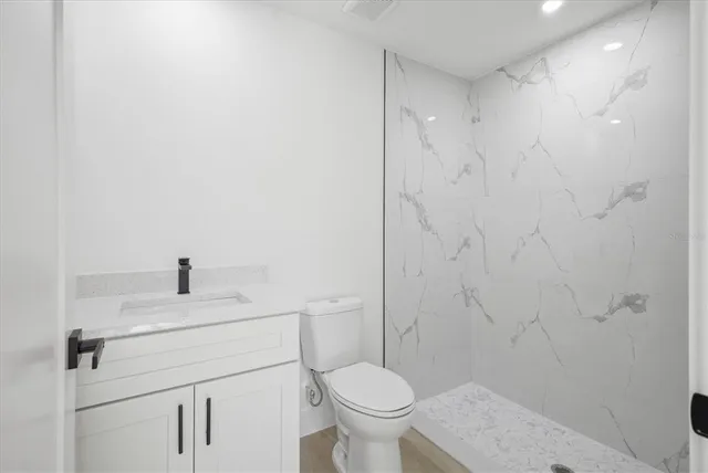 a bathroom with a sink toilet and a mirror