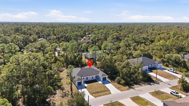 an aerial view of a house with a yard