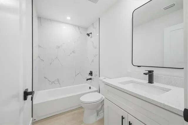 a bathroom with a sink a toilet and a bathtub