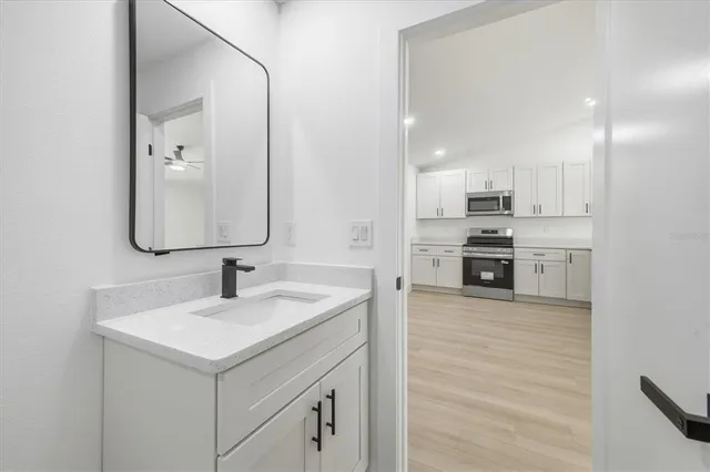 a large white kitchen with a sink and dishwasher