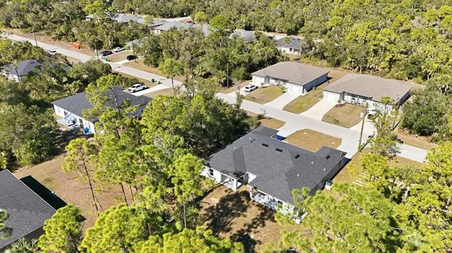 an aerial view of a house with a yard and garden