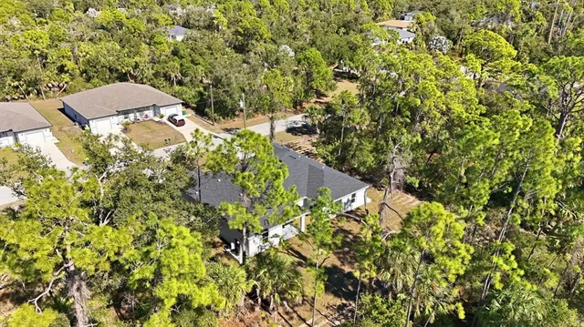 an aerial view of a house with a yard basket ball court and outdoor seating