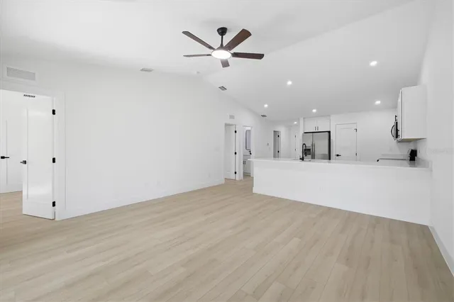 a view of kitchen with cabinet and window