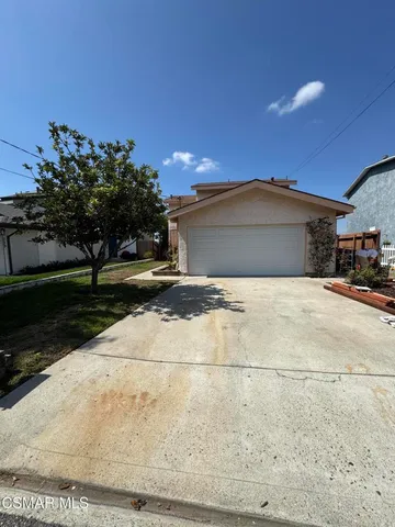 a view of the house with a yard