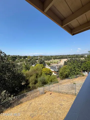 a view of a hallway with a livingroom and a bathroom space