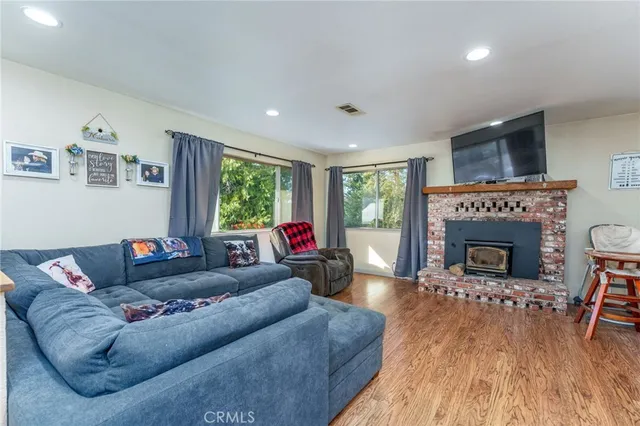 a living room with furniture window and a flat screen tv