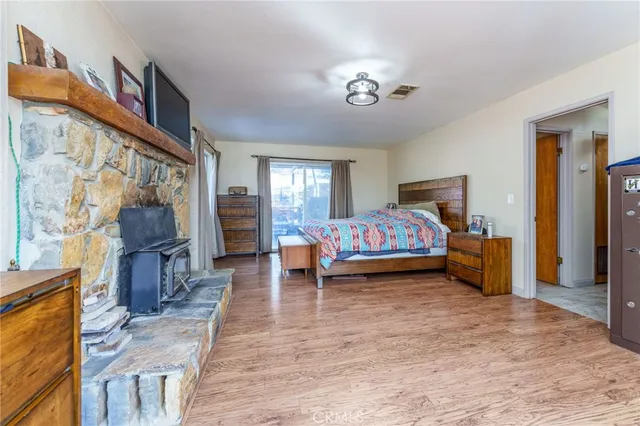 a bedroom with furniture and a flat screen tv