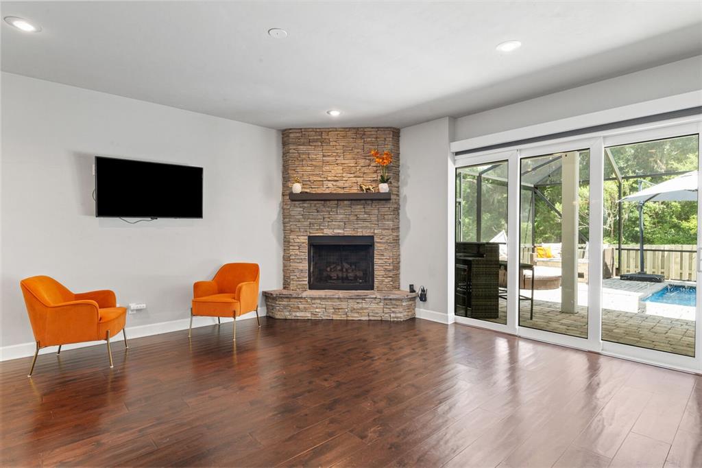 4855 Southwest 64th Road Gainesville, FL 32608 - Photo 12 of 44 a living room with furniture a flat screen tv and a fireplace