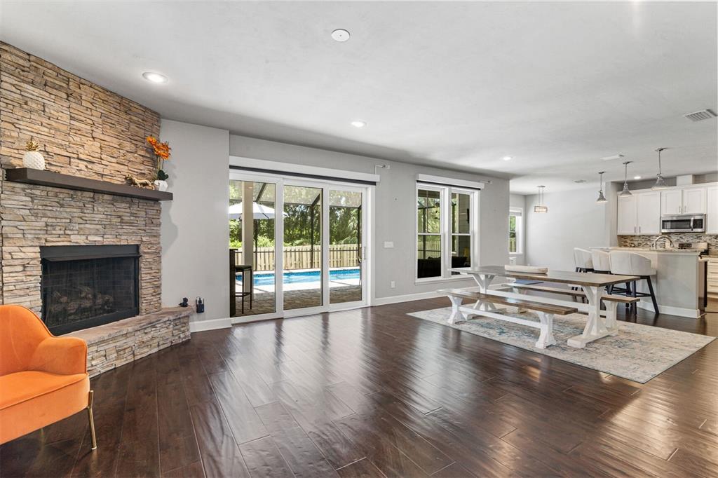 4855 Southwest 64th Road Gainesville, FL 32608 - Photo 13 of 44 a living room with furniture large window and wooden floor