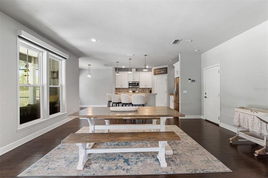 4855 Southwest 64th Road Gainesville, FL 32608 - Photo 14 of 44 a large white kitchen with kitchen island a stove a sink and a large window