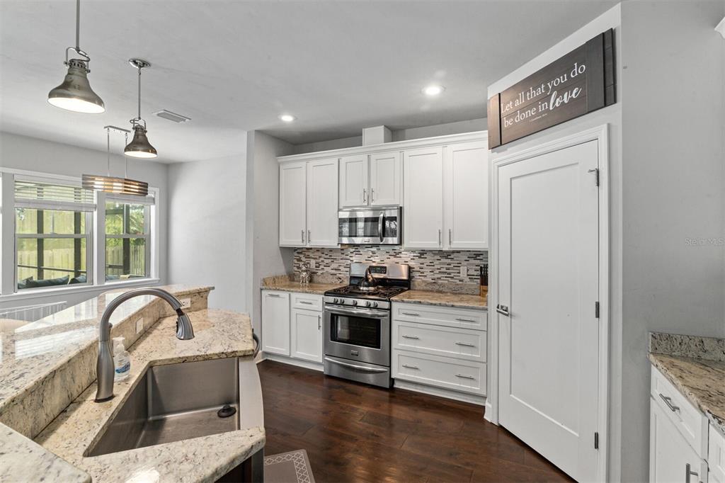 4855 Southwest 64th Road Gainesville, FL 32608 - Photo 17 of 44 a kitchen with stainless steel appliances granite countertop a sink stove and refrigerator