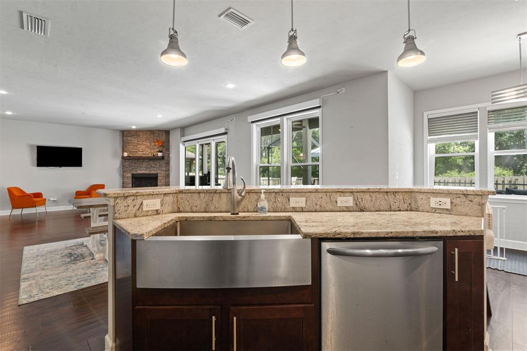 4855 Southwest 64th Road Gainesville, FL 32608 - Photo 18 of 44 a room with granite countertop a sink and a stove