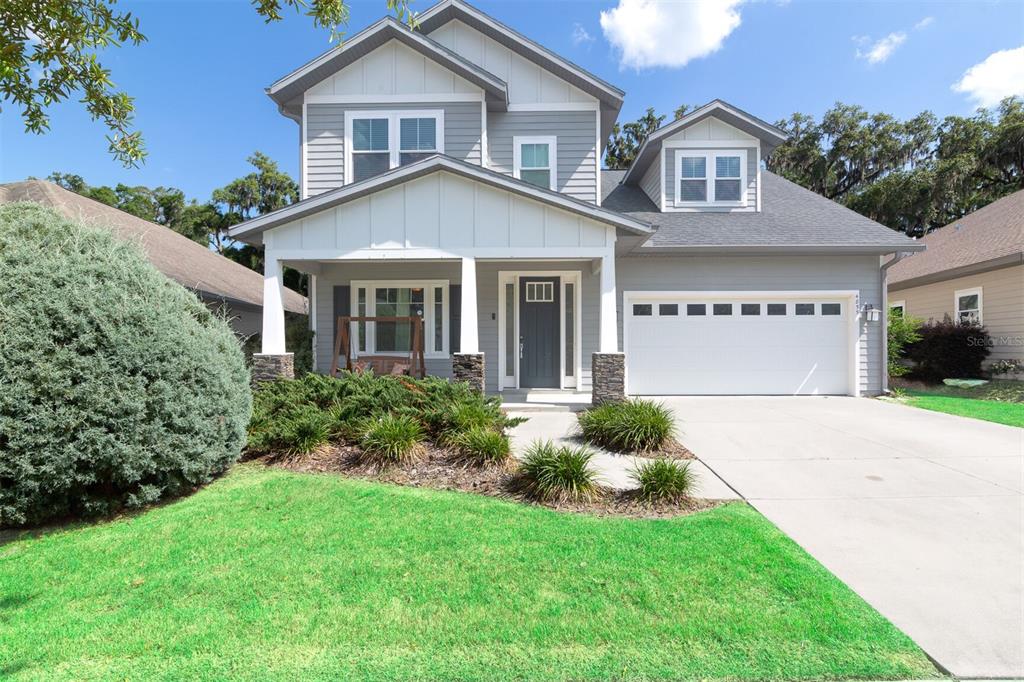 4855 Southwest 64th Road Gainesville, FL 32608 - Photo 2 of 44 a front view of a house with a yard and garage