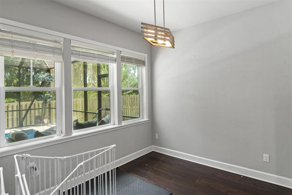 4855 Southwest 64th Road Gainesville, FL 32608 - Photo 21 of 44 a view of an empty room with wooden floor and a window