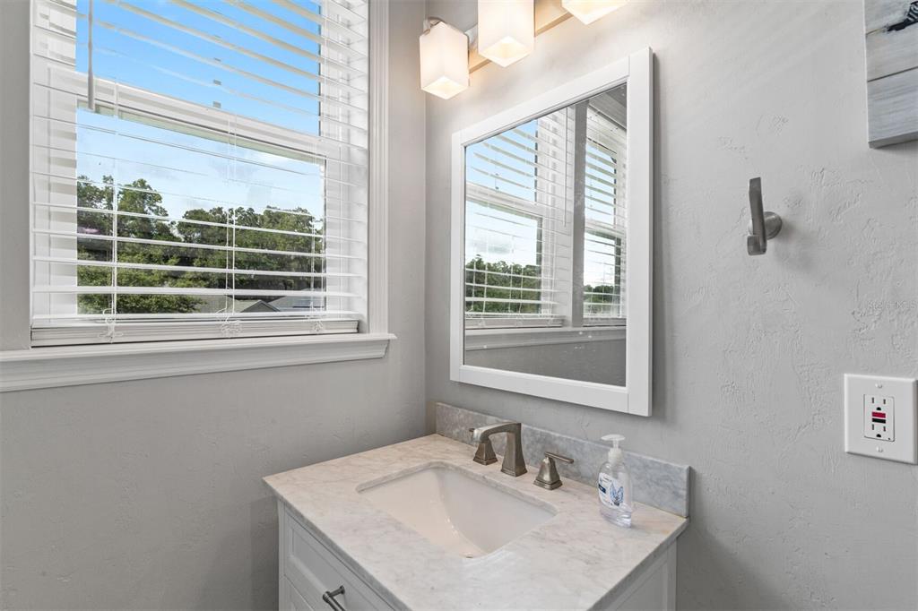 4855 Southwest 64th Road Gainesville, FL 32608 - Photo 26 of 44 a bathroom with a sink vanity and a mirror