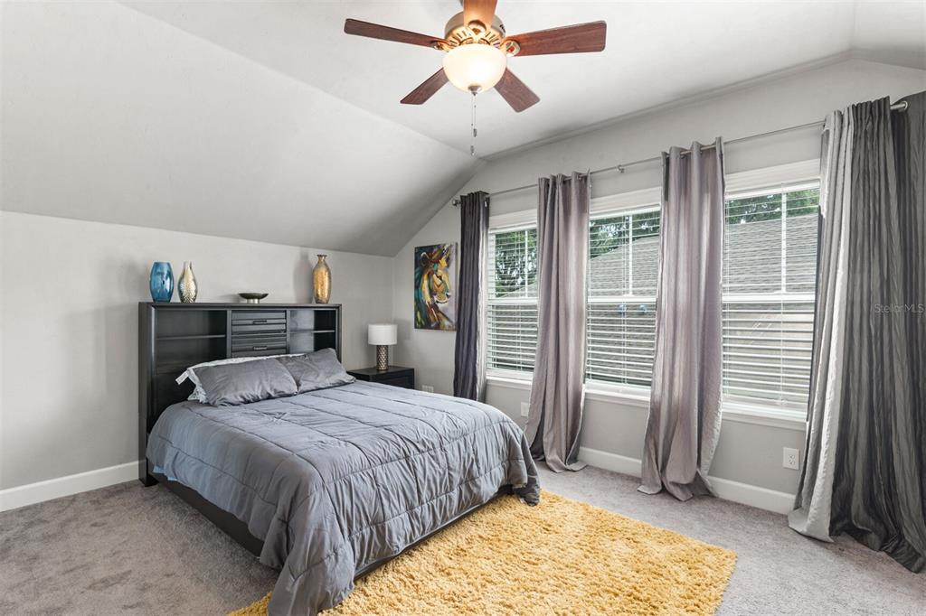 4855 Southwest 64th Road Gainesville, FL 32608 - Photo 28 of 44 a bedroom with a bed and a large window