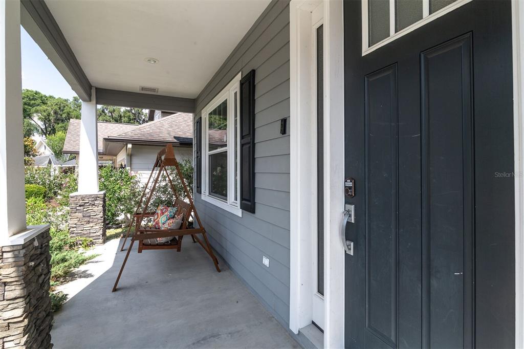 4855 Southwest 64th Road Gainesville, FL 32608 - Photo 3 of 44 a balcony with furniture and a potted plant