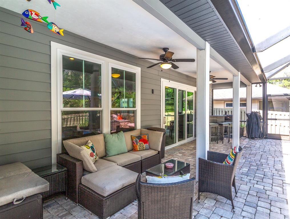 4855 Southwest 64th Road Gainesville, FL 32608 - Photo 37 of 44 a outdoor space with patio the couches and a dining table with the potted plants