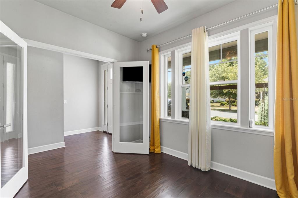 4855 Southwest 64th Road Gainesville, FL 32608 - Photo 8 of 44 a view of an empty room with wooden floor and a window