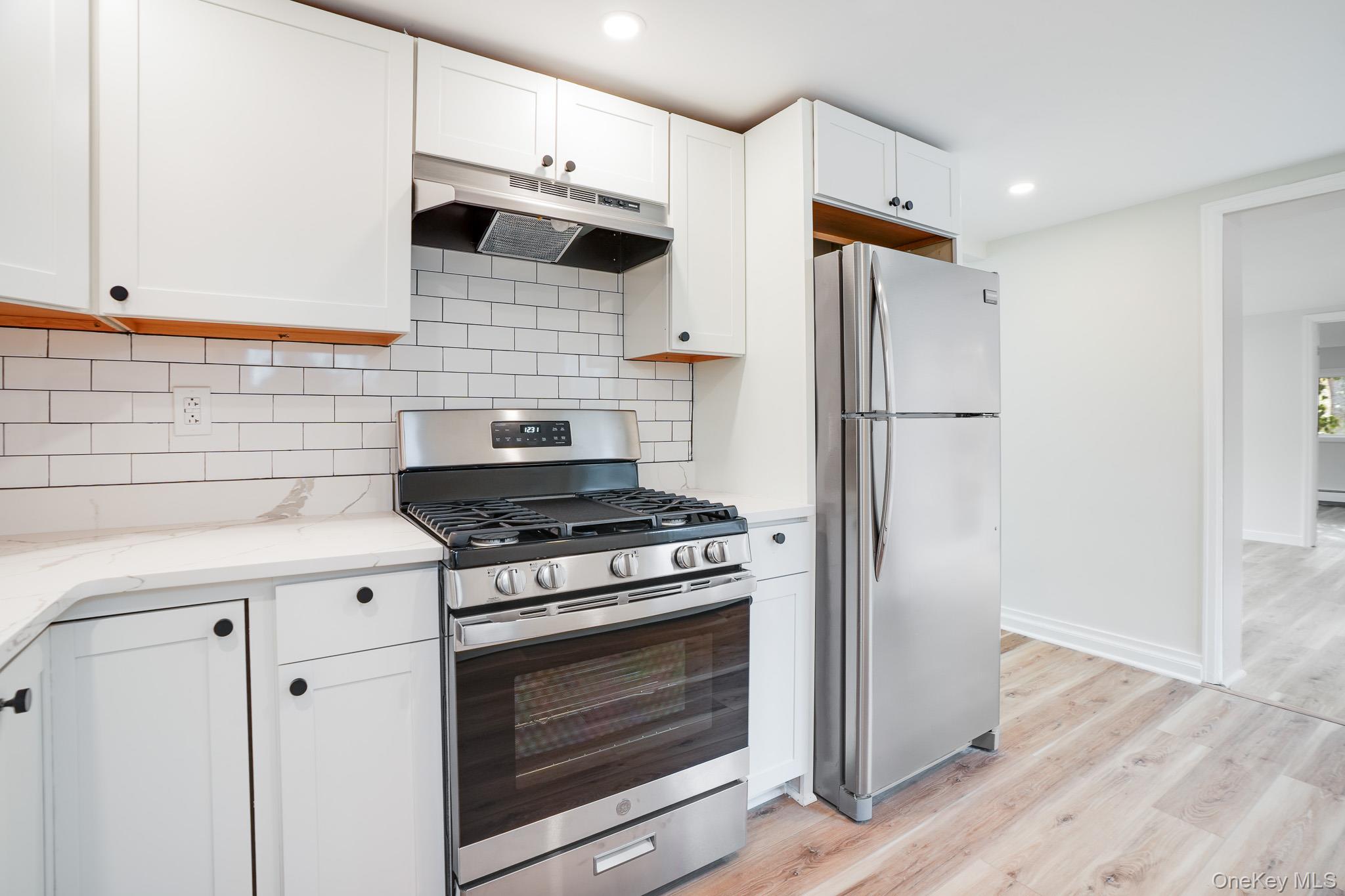 3 Pond Road Hyde Park, NY 12601 - Photo 11 of 34 a kitchen with stainless steel appliances a stove a refrigerator and cabinets