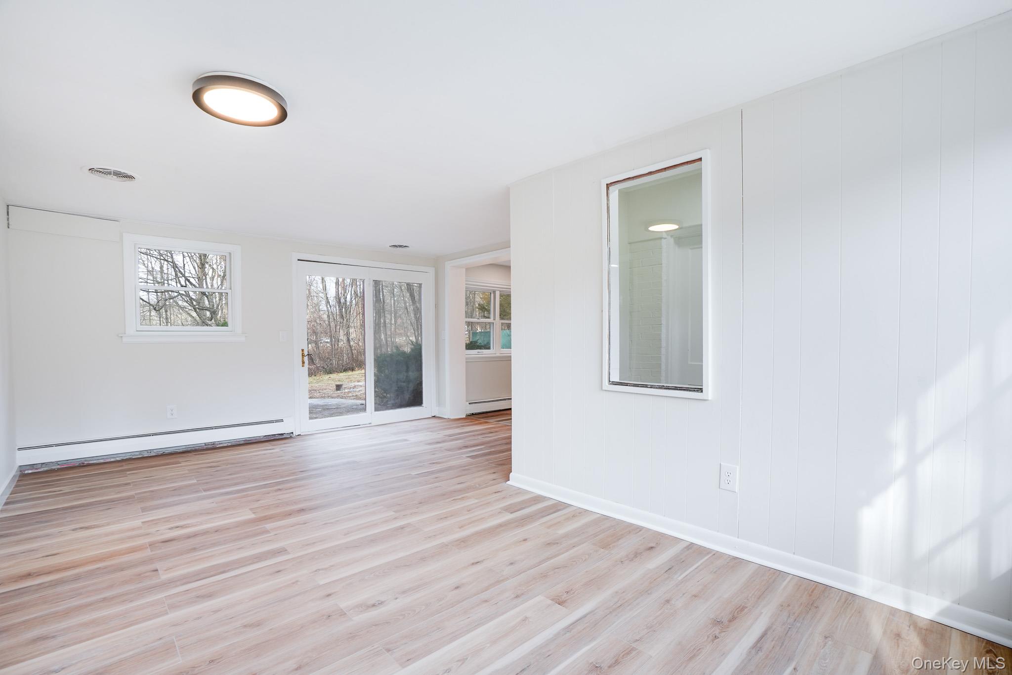 3 Pond Road Hyde Park, NY 12601 - Photo 14 of 34 a view of an empty room with wooden floor and a window