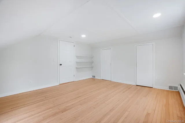 an empty room with wooden floor