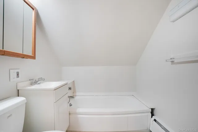 a view of a kitchen with a sink and refrigerator in a room