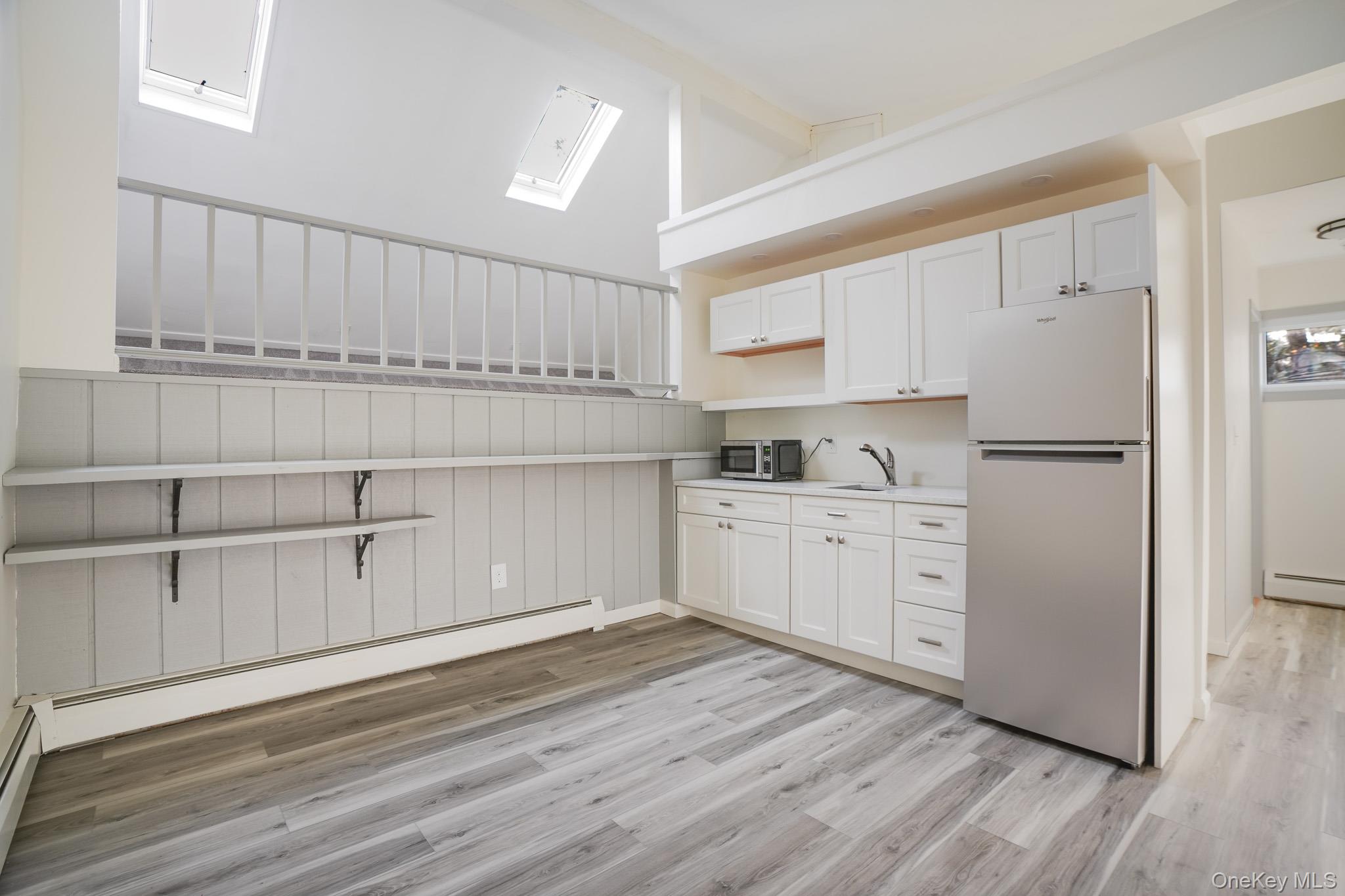 3 Pond Road Hyde Park, NY 12601 - Photo 22 of 34 a kitchen with white cabinets and white appliances