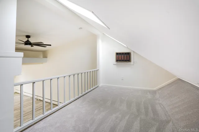a view of a hallway with wooden floor and windows