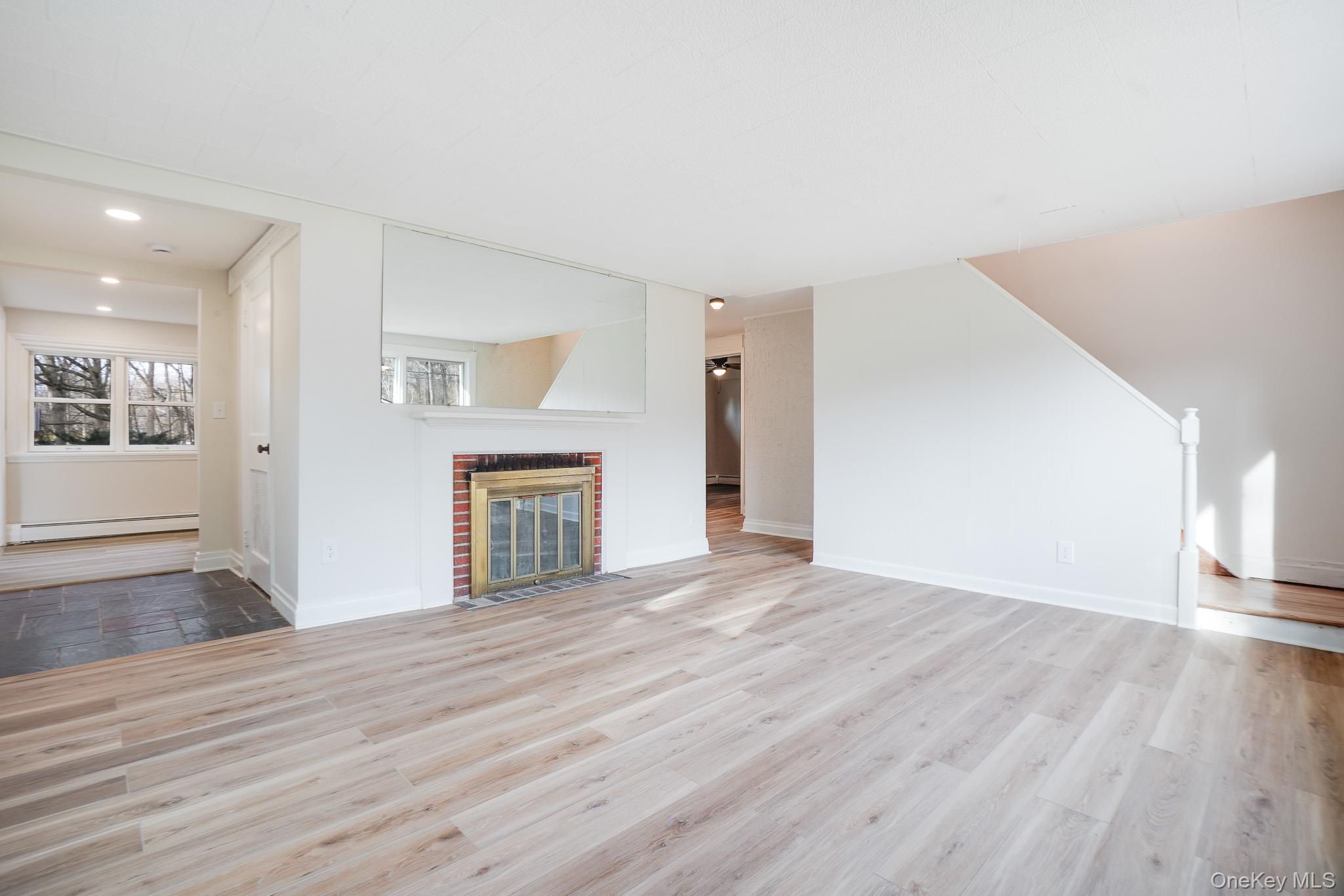 3 Pond Road Hyde Park, NY 12601 - Photo 4 of 34 a view of empty room with wooden floor and fireplace