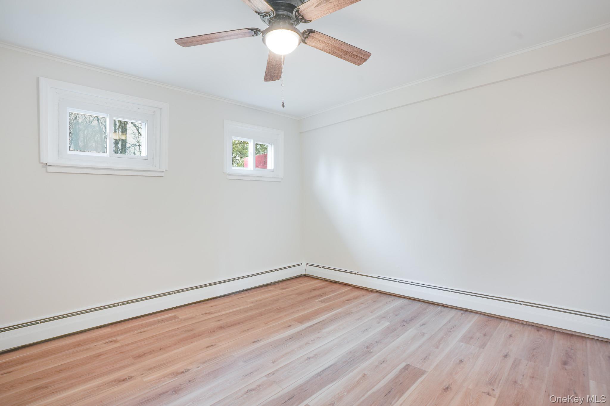 3 Pond Road Hyde Park, NY 12601 - Photo 5 of 34 a view of an empty room with wooden floor and a ceiling fan