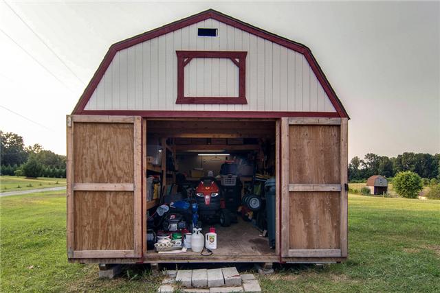 378 Howard Road White Bluff, TN 37187 - Photo 19 of 20 Storage shed has work shop and electricity. 54inch cut riding lawn mower stays with the house!