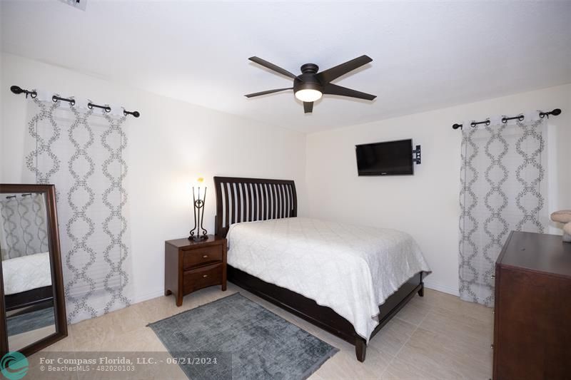 1224 Northwest 15th Street Boca Raton, FL 33486 - Photo 13 of 20 a bedroom with a bed and a television