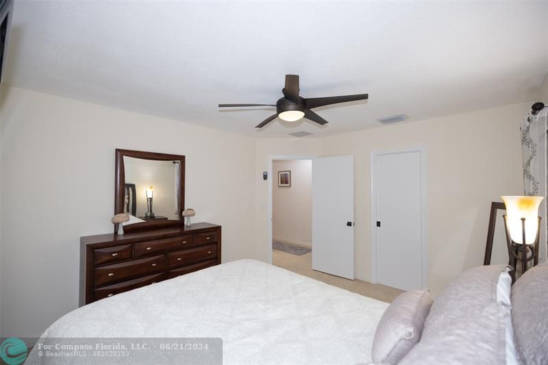 1224 Northwest 15th Street Boca Raton, FL 33486 - Photo 14 of 20 a bedroom with a bed and a chandelier