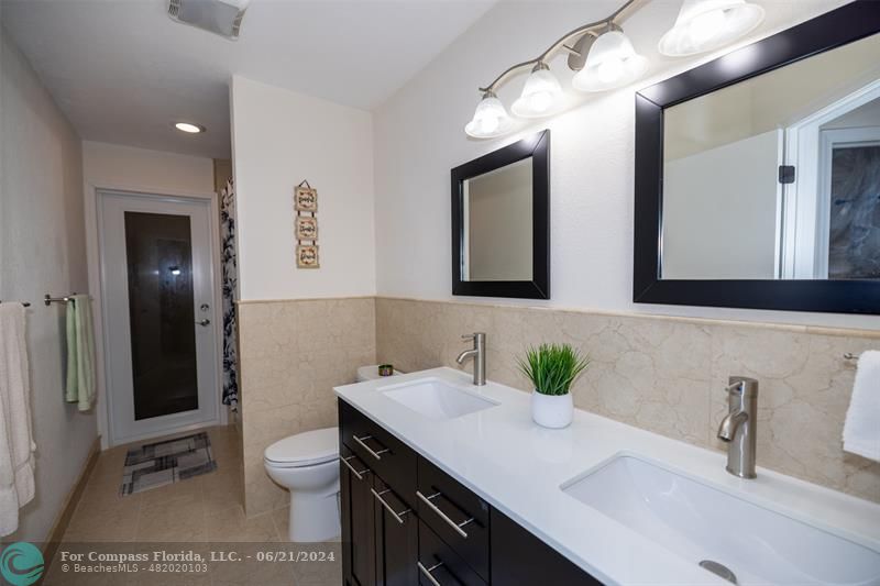 1224 Northwest 15th Street Boca Raton, FL 33486 - Photo 18 of 20 a bathroom with a sink and a mirror