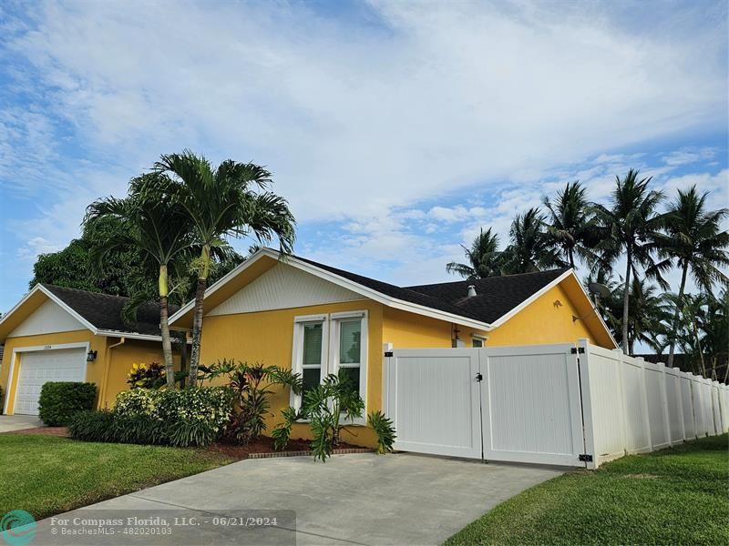 1224 Northwest 15th Street Boca Raton, FL 33486 - Photo 20 of 20 a front view of a house with garden