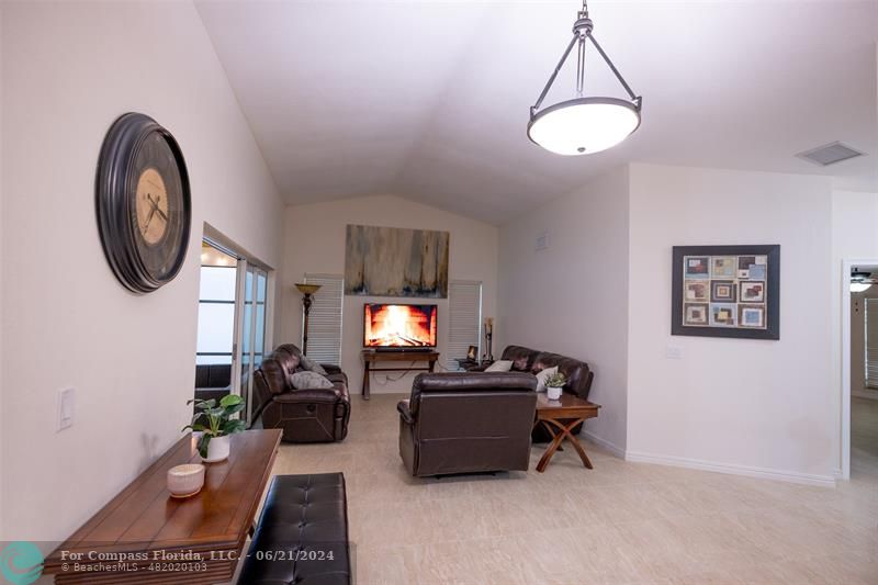 1224 Northwest 15th Street Boca Raton, FL 33486 - Photo 10 of 20 a living room with furniture a window and a flat screen tv