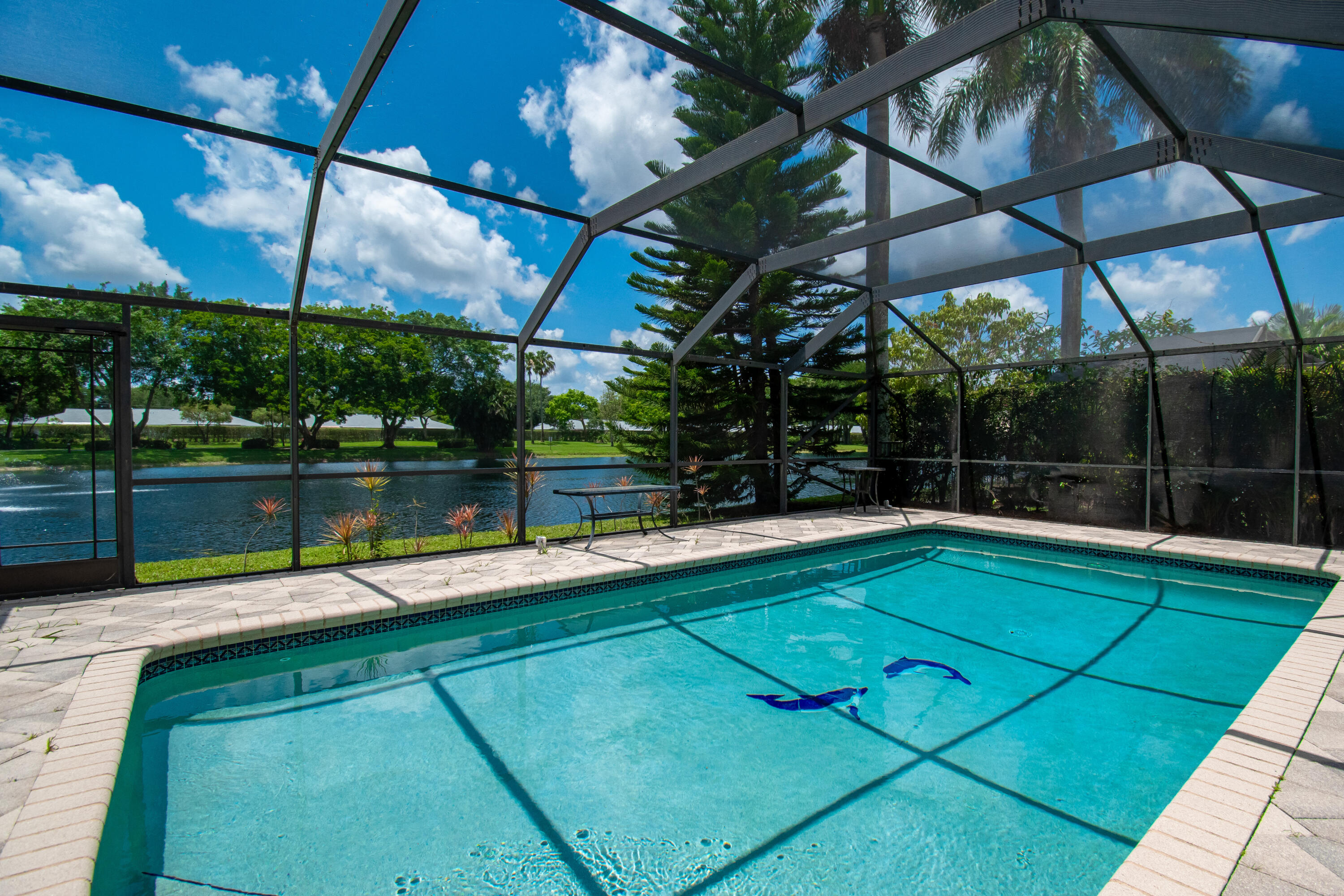 9708 Erica Court Boca Raton, FL 33496 - Photo 42 of 54 a view of a swimming pool with a bench in front of it