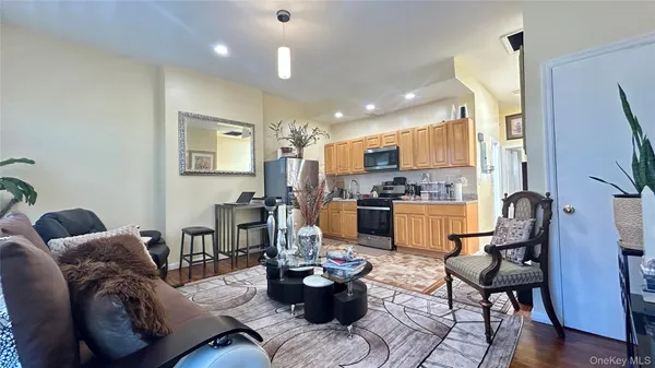 a living room with furniture and kitchen view