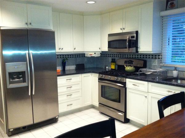 129 Hampton Road Sharon, MA 02067 - Photo 2 of 10 a kitchen with cabinets stainless steel appliances and a counter space