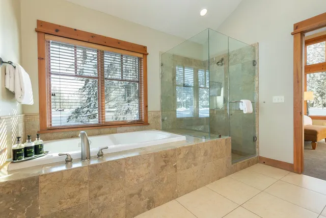a spacious bathroom with a granite countertop tub shower and sink