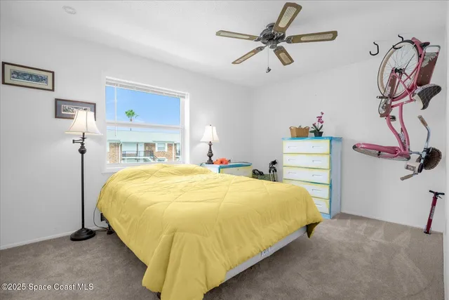 a bedroom with a bed and ceiling fan