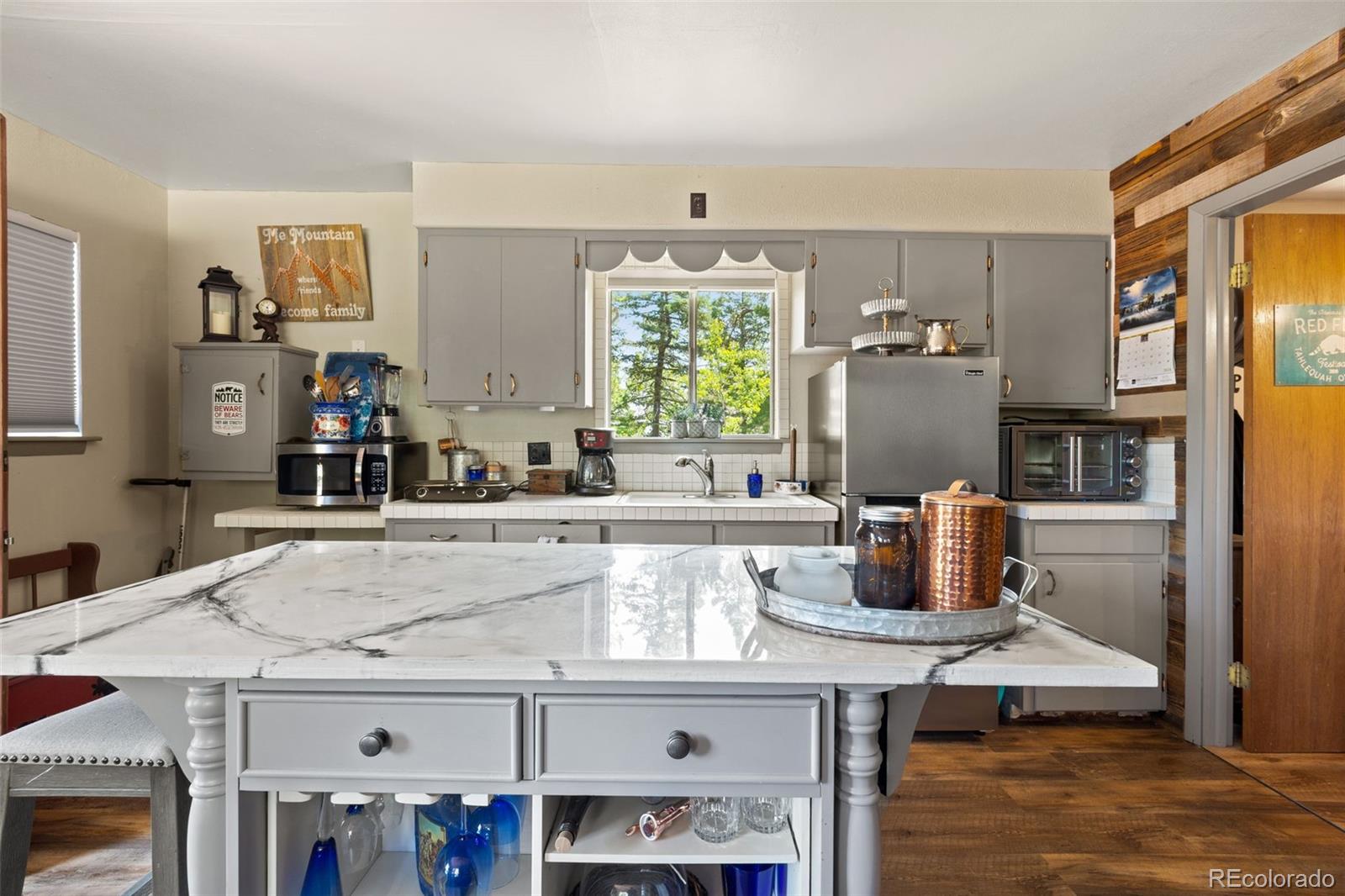 9796 Highway 165 Rye, CO 81069 - Photo 10 of 24 a kitchen with a white cabinets and chairs