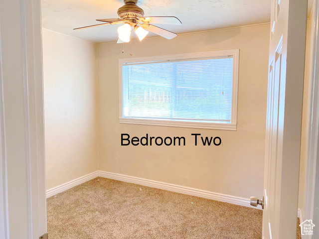 247 West 400 North, Unit 1 Moab, UT 84532 - Photo 16 of 27 Carpeted empty room with baseboards and ceiling fan