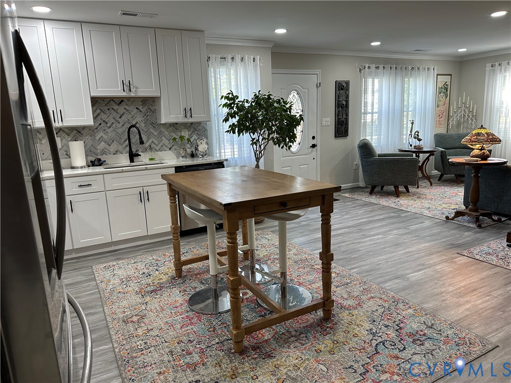 305 Myrtle Street, Unit A Ashland, VA 23005 - Photo 11 of 59 a kitchen with kitchen island granite countertop a sink a stove a microwave cabinets and a dining table