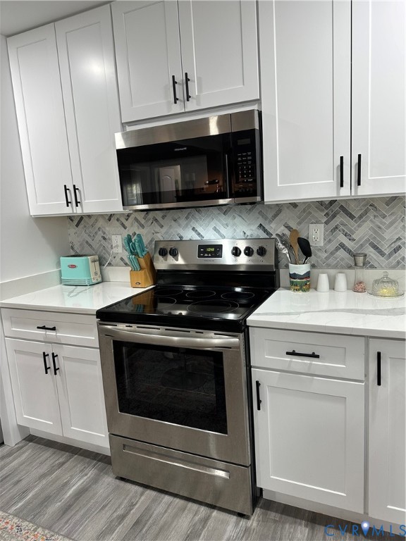 305 Myrtle Street, Unit A Ashland, VA 23005 - Photo 12 of 59 a kitchen with a stove and a sink